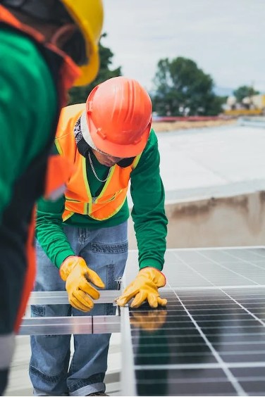 A technician installing solar panels